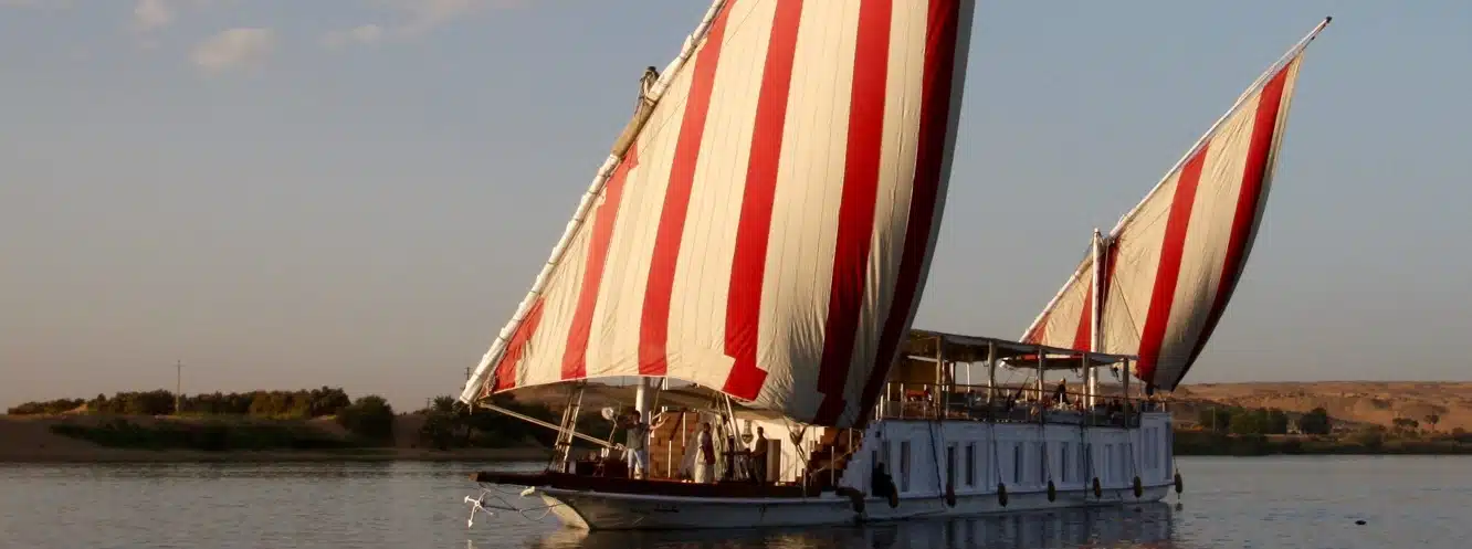Assouan Dahabiya traditional sailing boat on the Nile with classic white sails