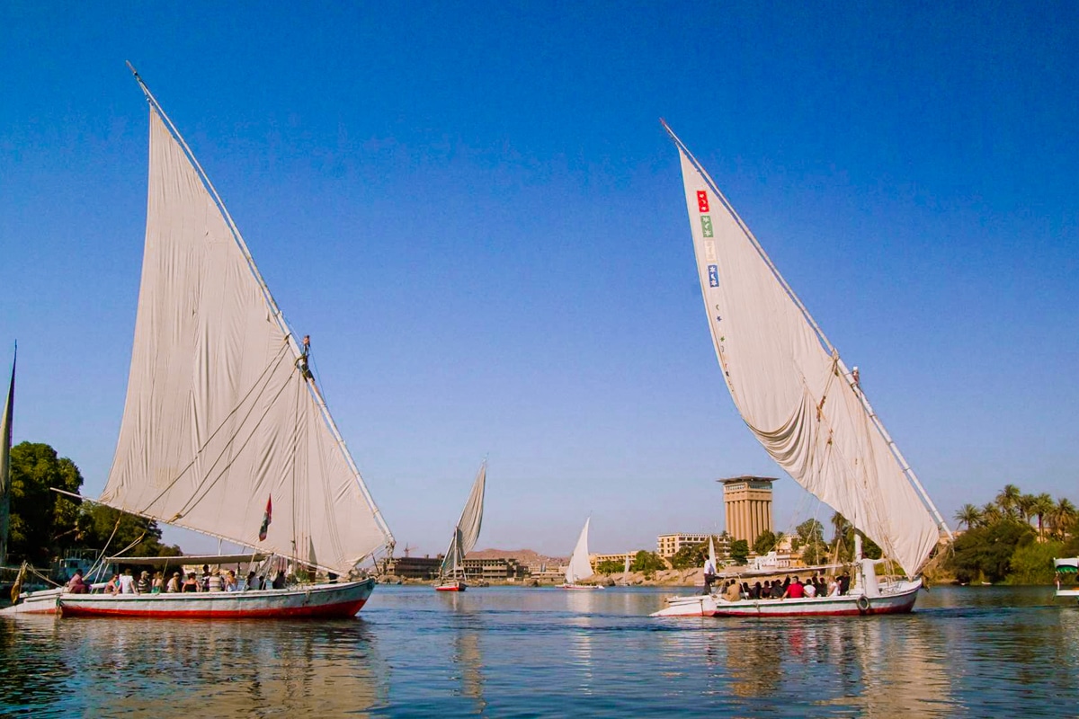 Feluccas sailing near Aswan on Nile River cruise Egypt