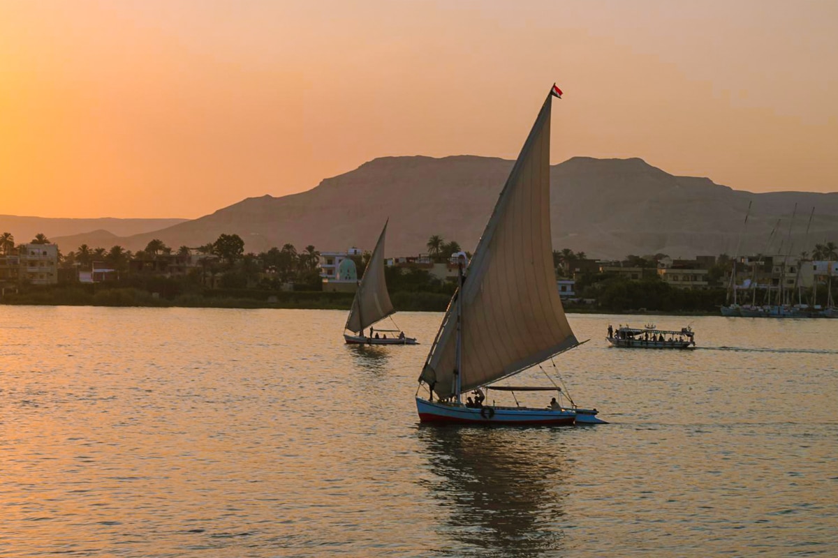 Traditional felucca sailing on the Nile at sunset in Egypt